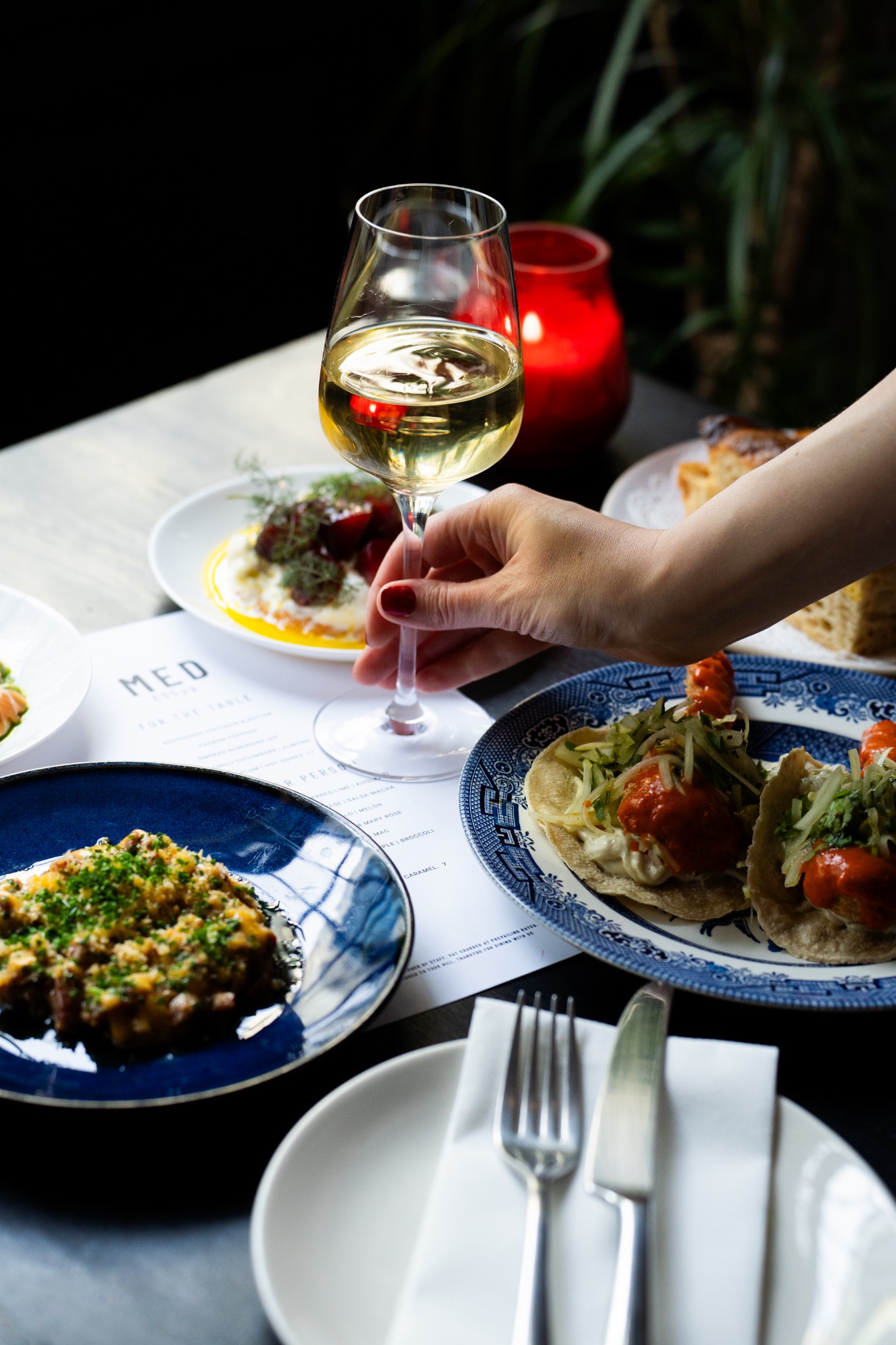 Med dishes being served around a table