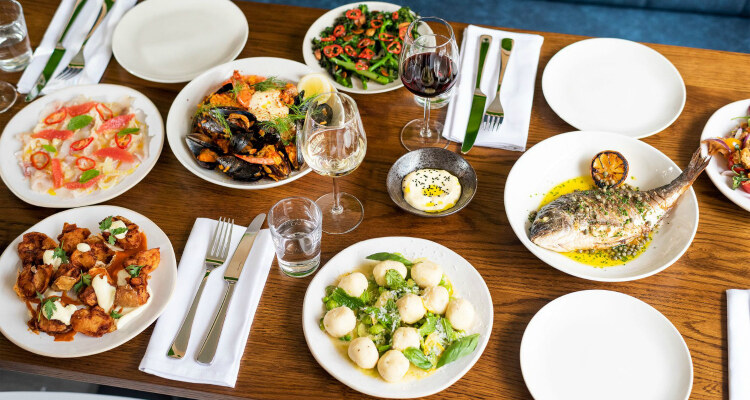 A table filled with sharing dishes from Med